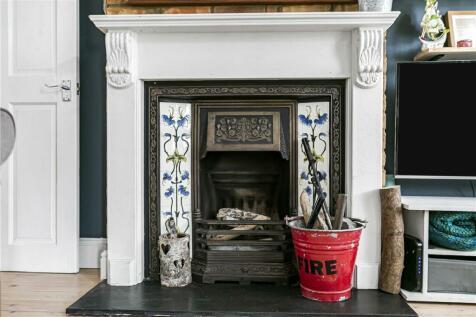 cast fireplace with decorative tiles